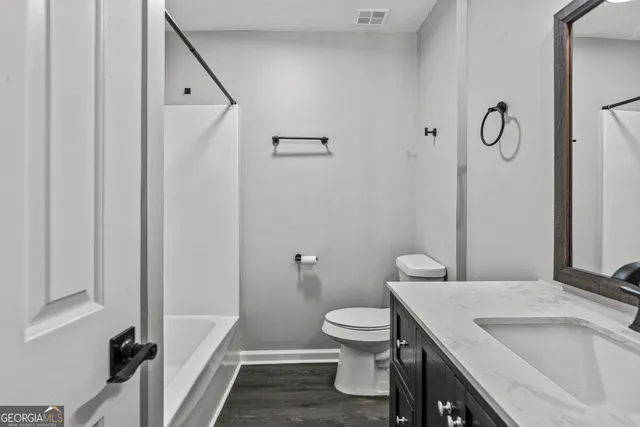 a bathroom with a sink and toilet