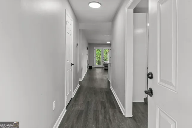 a view of a hallway with wooden floor