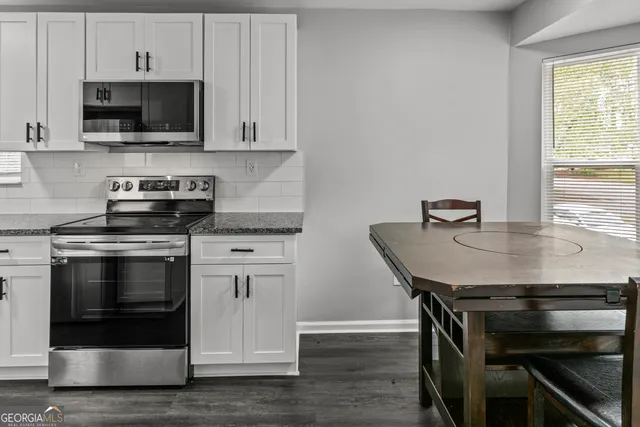 a kitchen with a stove and a microwave