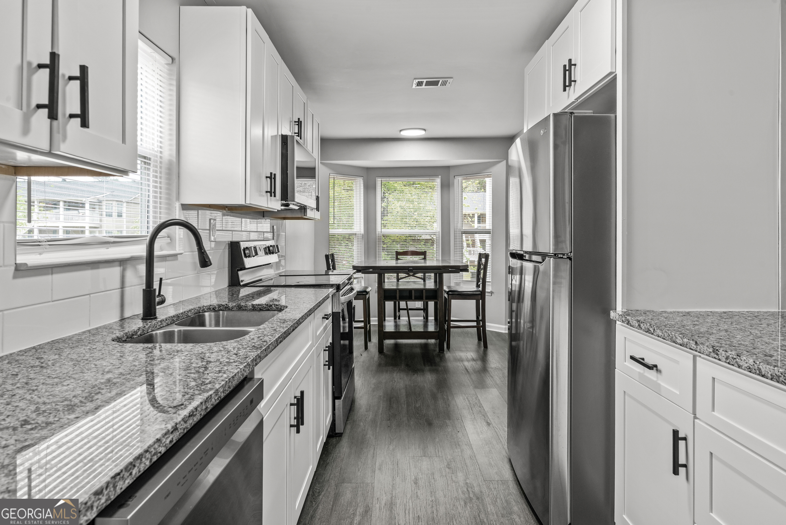 140 Cumberland Court Athens, GA 30607 - Photo 5 of 19 a kitchen with granite countertop a sink stove and cabinets