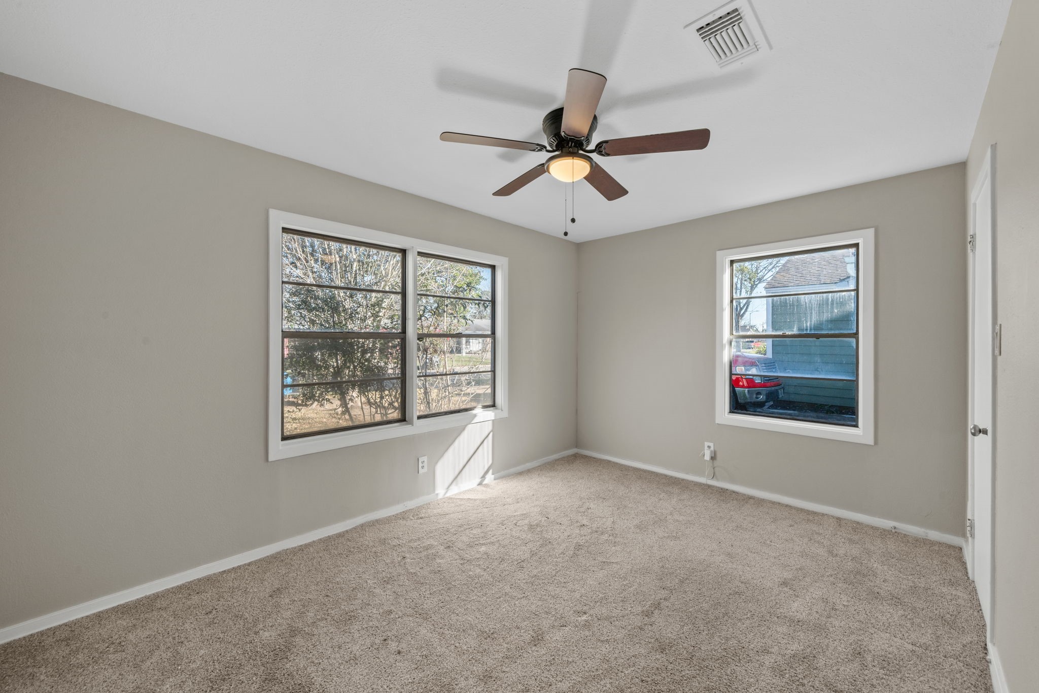 4110 Friar Point Road Houston, TX 77047 - Photo 11 of 15 a view of an empty room with a window and a kitchen