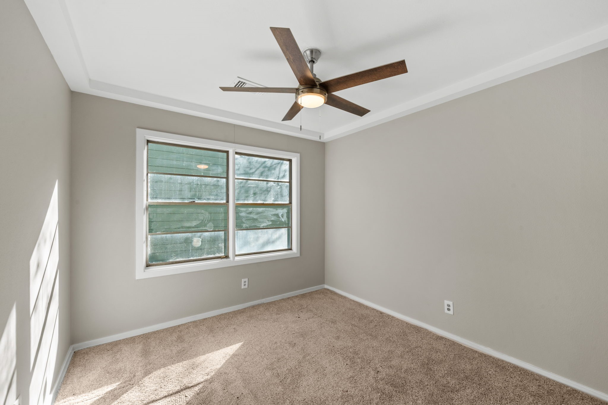 4110 Friar Point Road Houston, TX 77047 - Photo 13 of 15 an empty room with a window and a fan