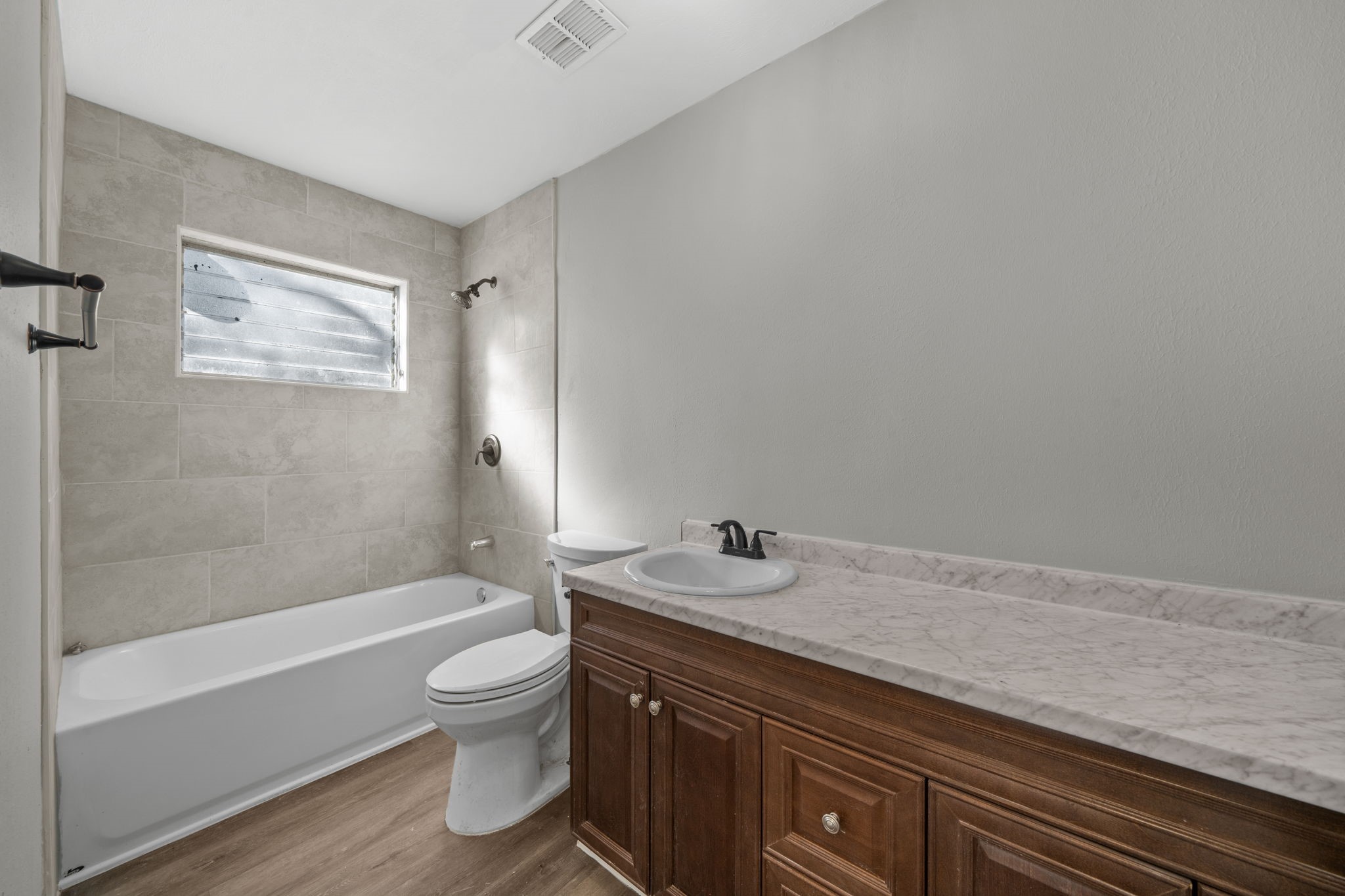 4110 Friar Point Road Houston, TX 77047 - Photo 14 of 15 a bathroom with a granite countertop sink toilet and shower