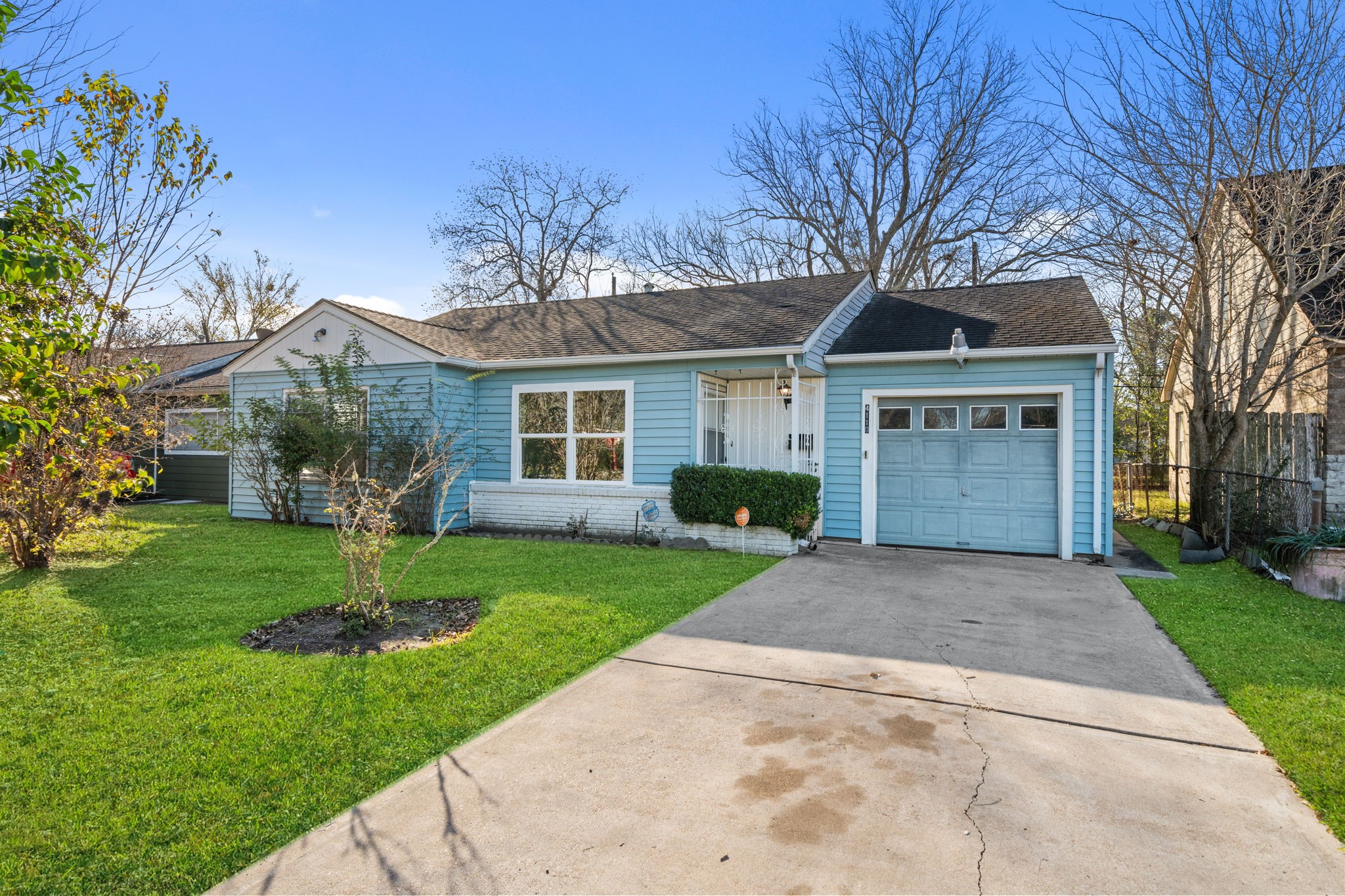 4110 Friar Point Road Houston, TX 77047 - Photo 4 of 15 a front view of a house with a yard and garage