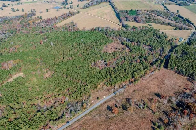 an aerial view of a house with a yard and lake view