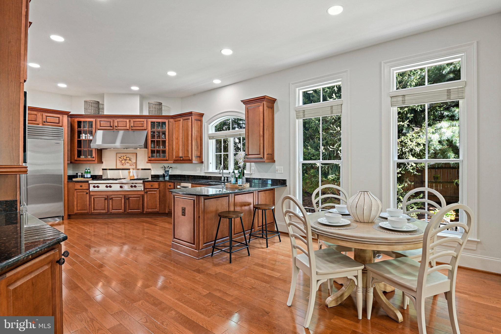 8424 Falcone Pointe Way Vienna, VA 22182 - Photo 19 of 71 a kitchen with stainless steel appliances kitchen island granite countertop a sink and cabinets