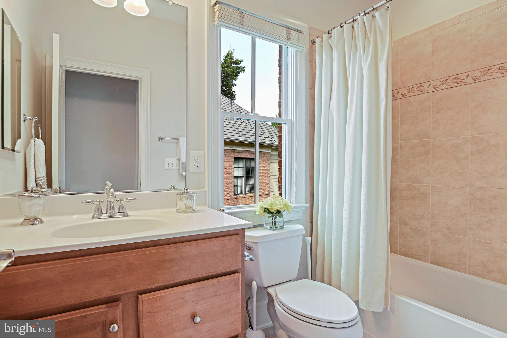 8424 Falcone Pointe Way Vienna, VA 22182 - Photo 28 of 71 a bathroom with a sink a toilet a tub and shower