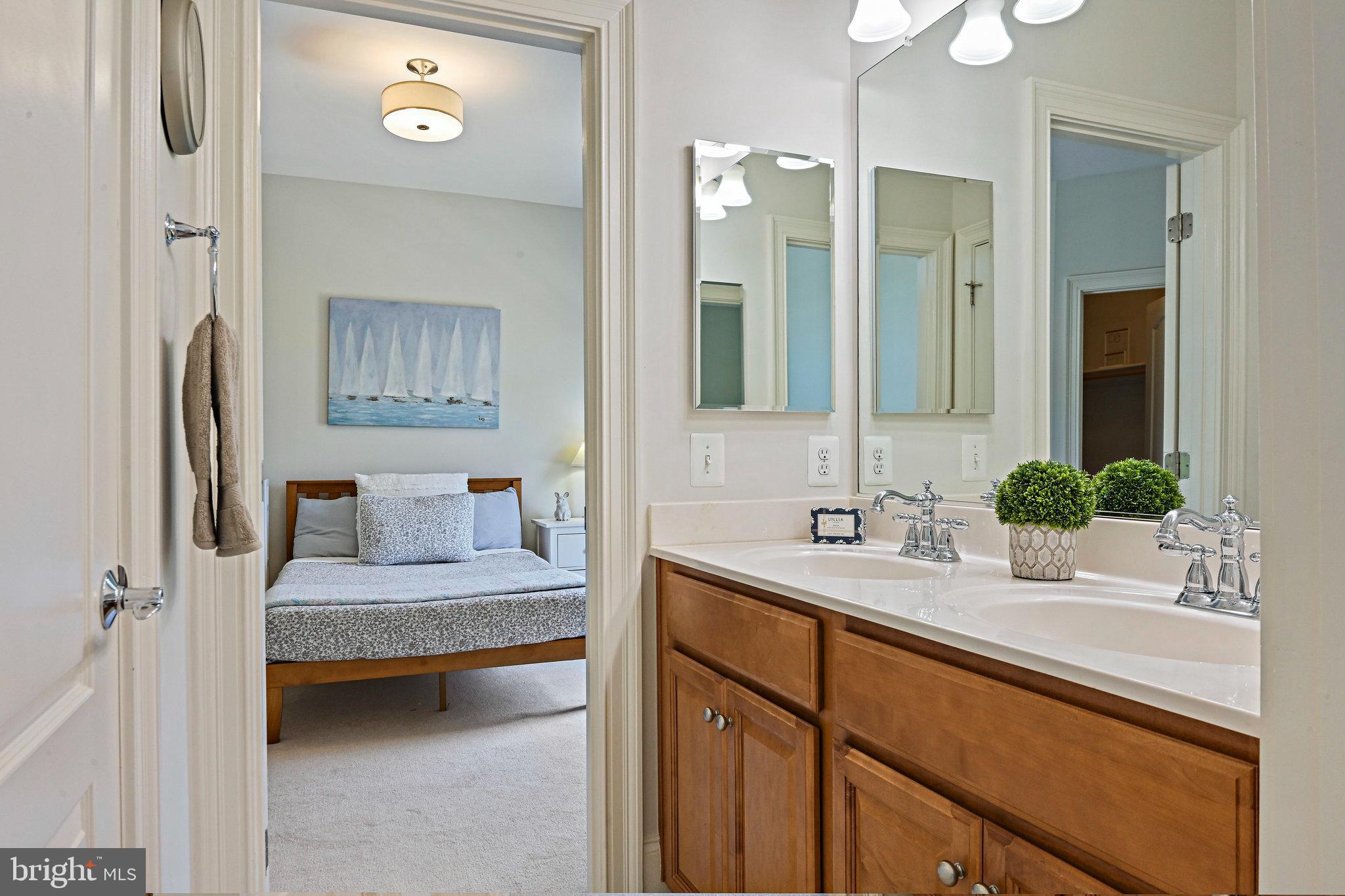 8424 Falcone Pointe Way Vienna, VA 22182 - Photo 33 of 71 a en suite bathroom with a double vanity sink and mirror
