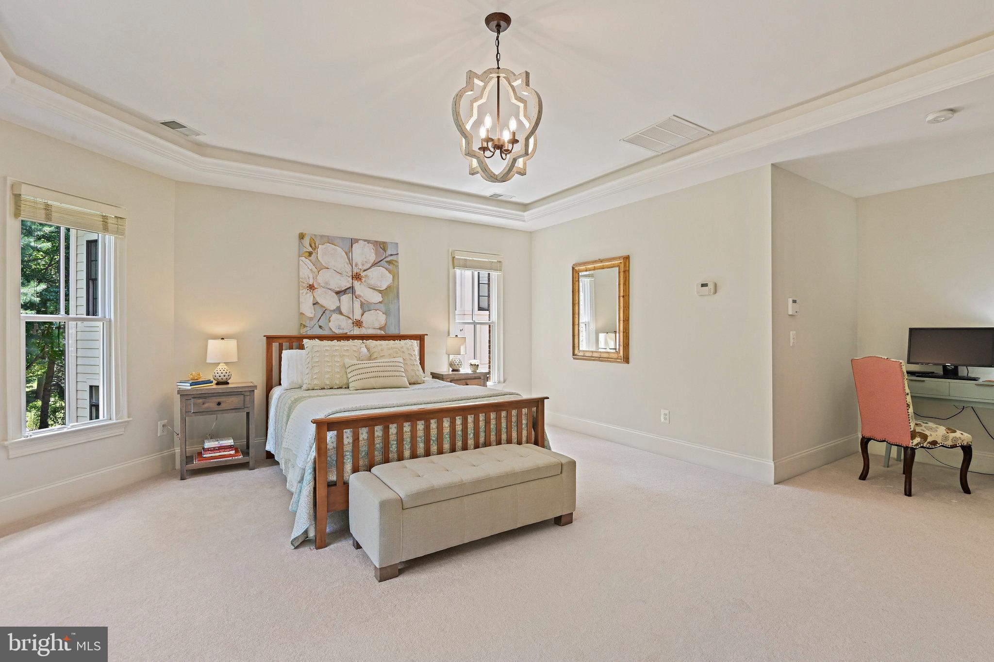 8424 Falcone Pointe Way Vienna, VA 22182 - Photo 41 of 71 a bedroom with a bed and a chandelier