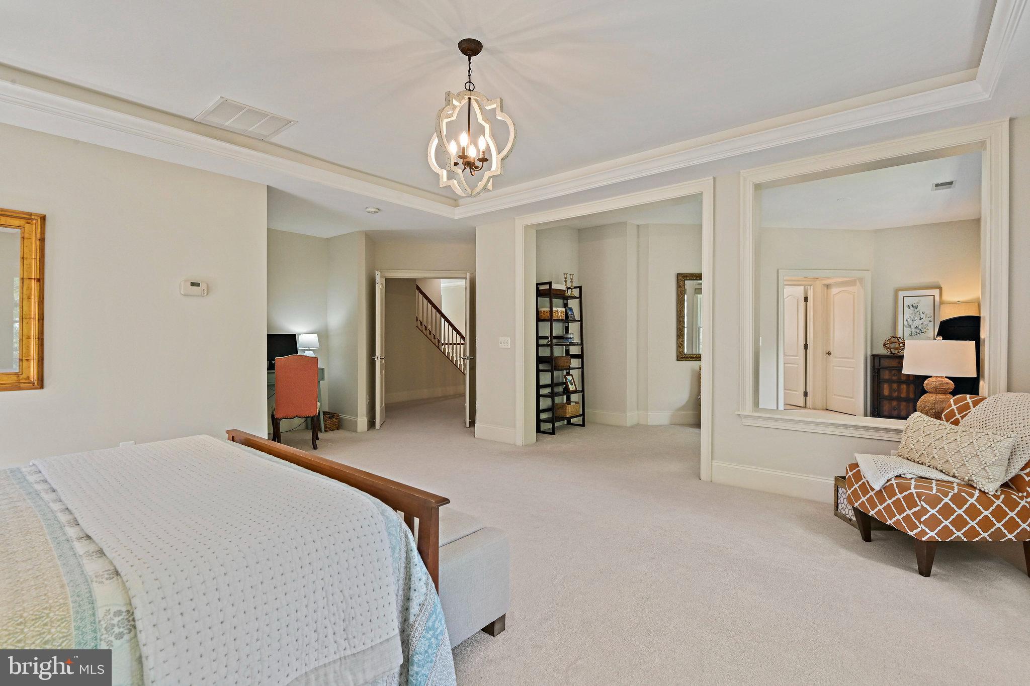 8424 Falcone Pointe Way Vienna, VA 22182 - Photo 42 of 71 a spacious bedroom with a bed and a chandelier