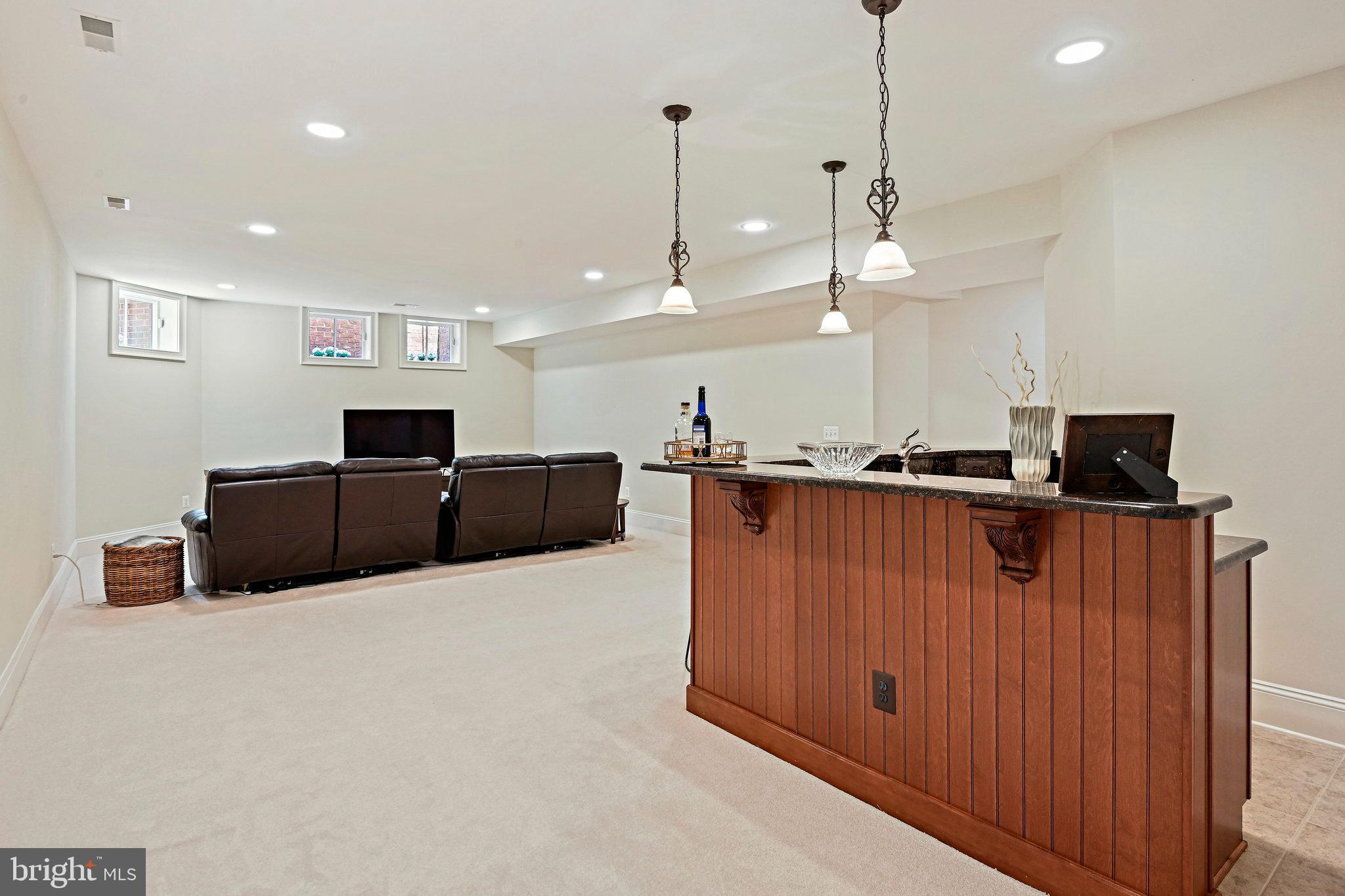 8424 Falcone Pointe Way Vienna, VA 22182 - Photo 65 of 71 a kitchen with stainless steel appliances kitchen island granite countertop a refrigerator a stove and a sink