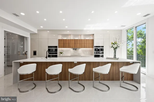 a kitchen with a sink a stove and cabinets
