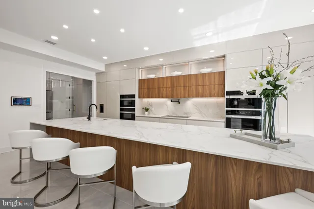 a bathroom with a granite countertop sink a toilet and a mirror