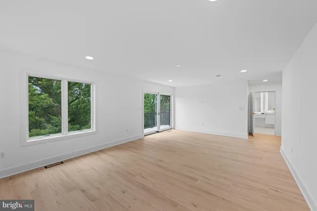 a living room with a fireplace and a large window