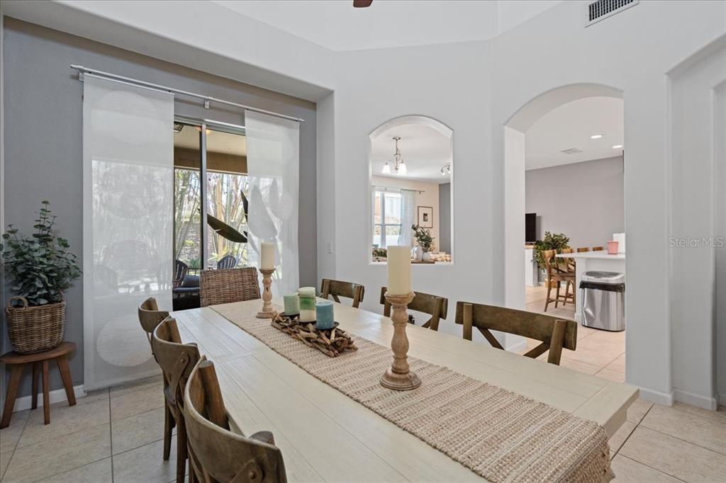 3271 Titanic Circle, Unit 39 Indialantic, FL 32903 - Photo 13 of 60 a dining room with wooden floor a glass table and chairs