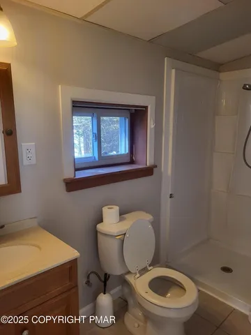 a white toilet sitting next to a bathroom sink