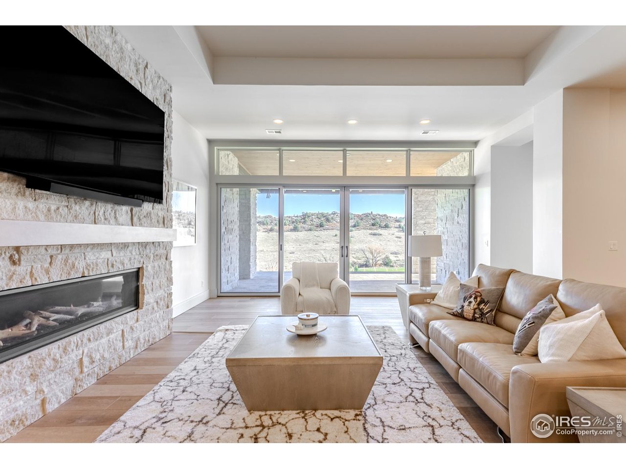 7572 Raphael Lane Littleton, CO 80125 - Photo 30 of 50 This light-filled walkout basement family room offers a refined yet relaxed gathering space, where expansive windows frame uninterrupted views of the golf course and fill the room with natural light.