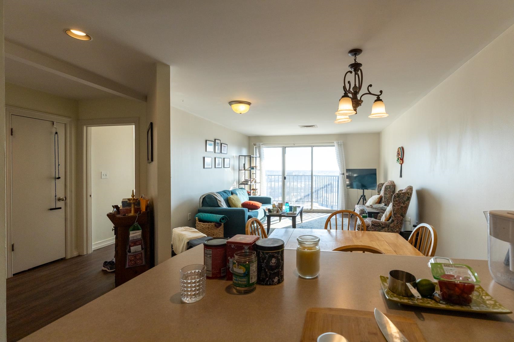 655 Riverside Drive, Unit 1008A Memphis, TN 38103 - Photo 10 of 10 Kitchen featuring hanging light fixtures, open floor plan, wood finished floors, light countertops, and recessed lighting