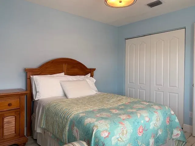 a bedroom with a bed and a mirror