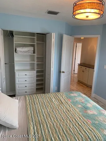 a bedroom with a bed and cabinets