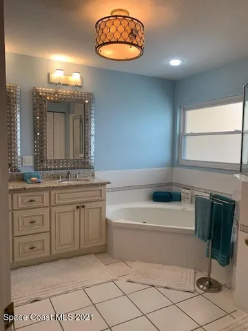a bathroom with a double vanity sink and a toilet