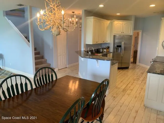 a kitchen with sink table and chairs