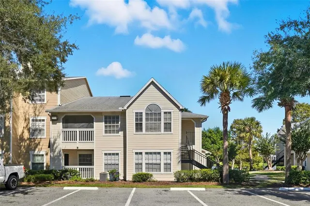 a view of a large white building next to a road