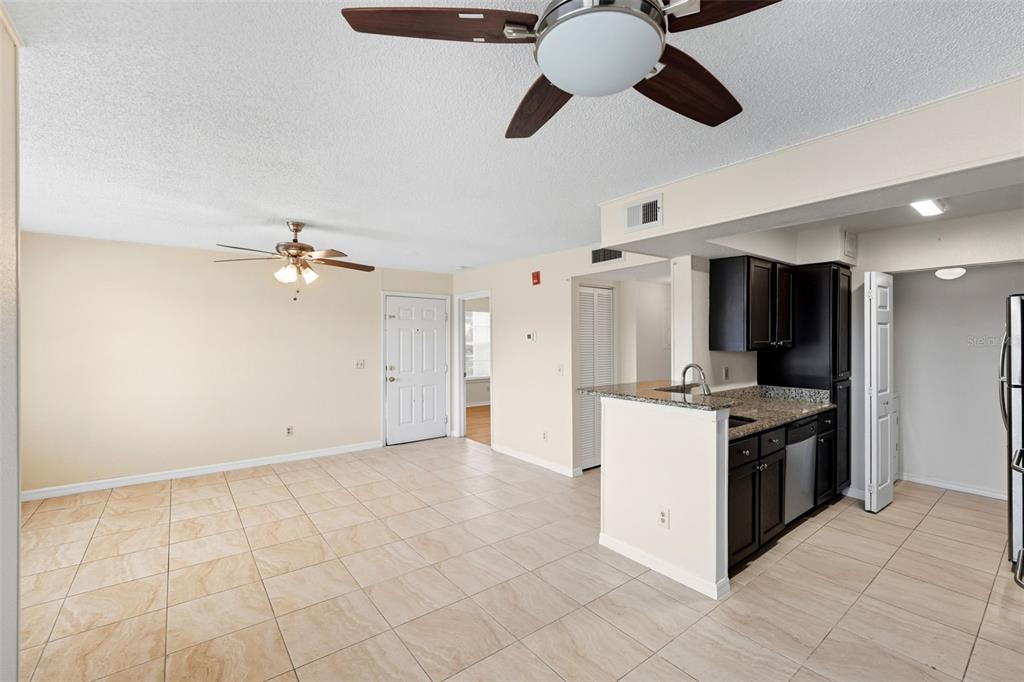 1039 South Hiawassee Road, Unit 2918 Orlando, FL 32835 - Photo 12 of 28 a kitchen with a stove and a refrigerator