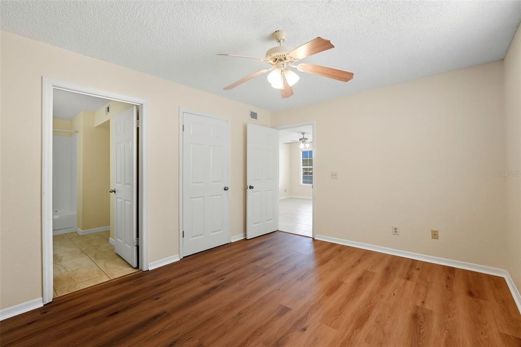 1039 South Hiawassee Road, Unit 2918 Orlando, FL 32835 - Photo 22 of 28 an empty room with wooden floor closet and windows