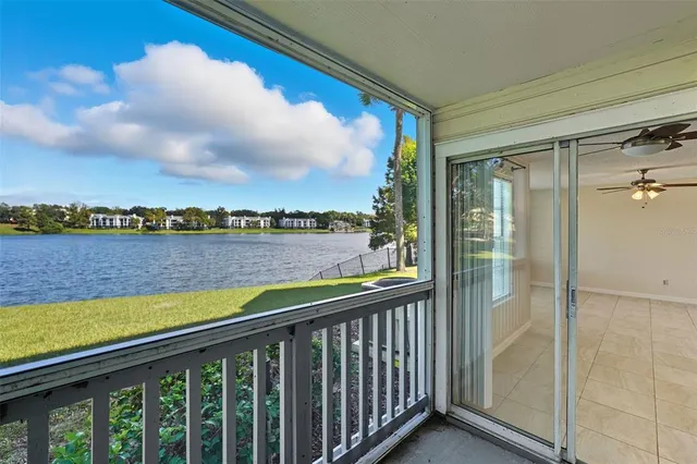 a view of residential houses with yard and car parked