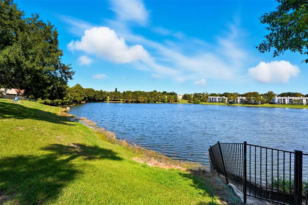 1039 South Hiawassee Road, Unit 2918 Orlando, FL 32835 - Photo 4 of 28 a view of a lake with houses in the back