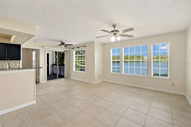 a view of an empty room with a kitchen