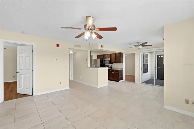 a view of a kitchen with a sink and a refrigerator