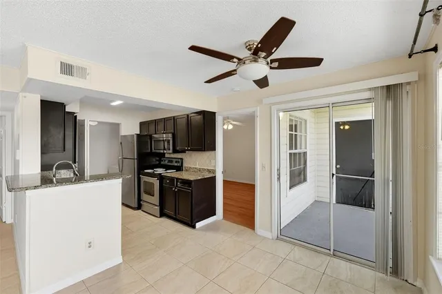 a view of a kitchen with a sink and stainless steel appliances
