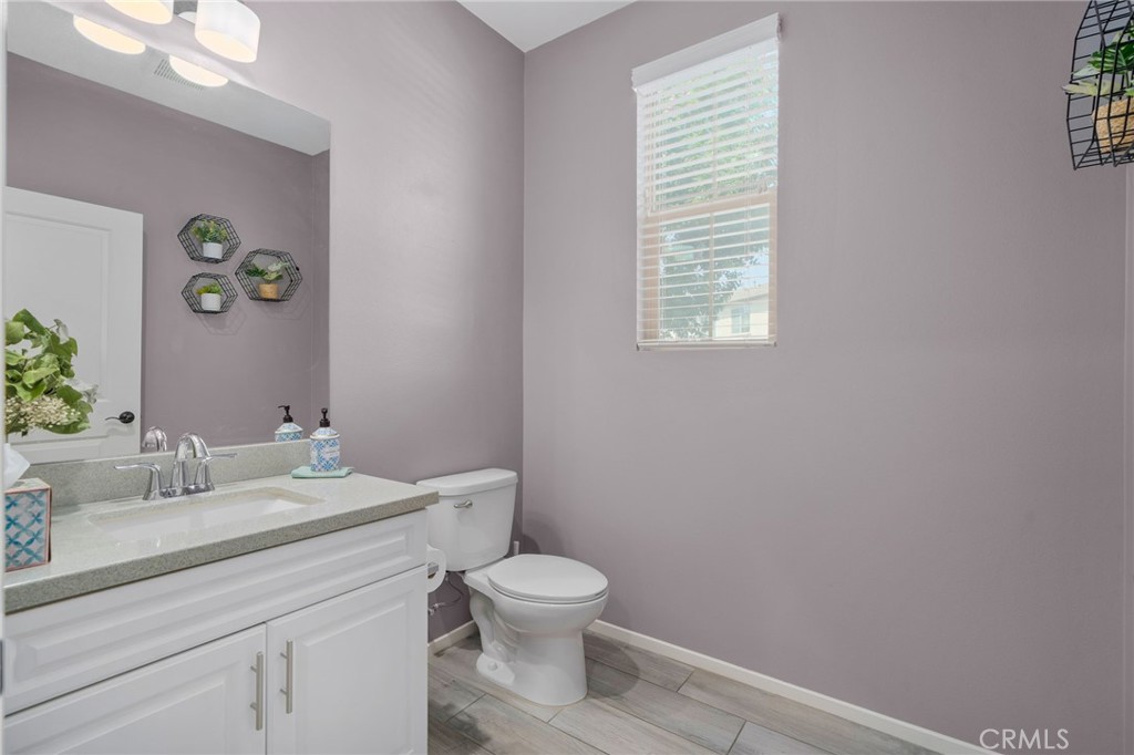 4171 South Cardinale Privado, Unit 2 Ontario, CA 91761 - Photo 12 of 30 a bathroom with a granite countertop toilet a sink and a window