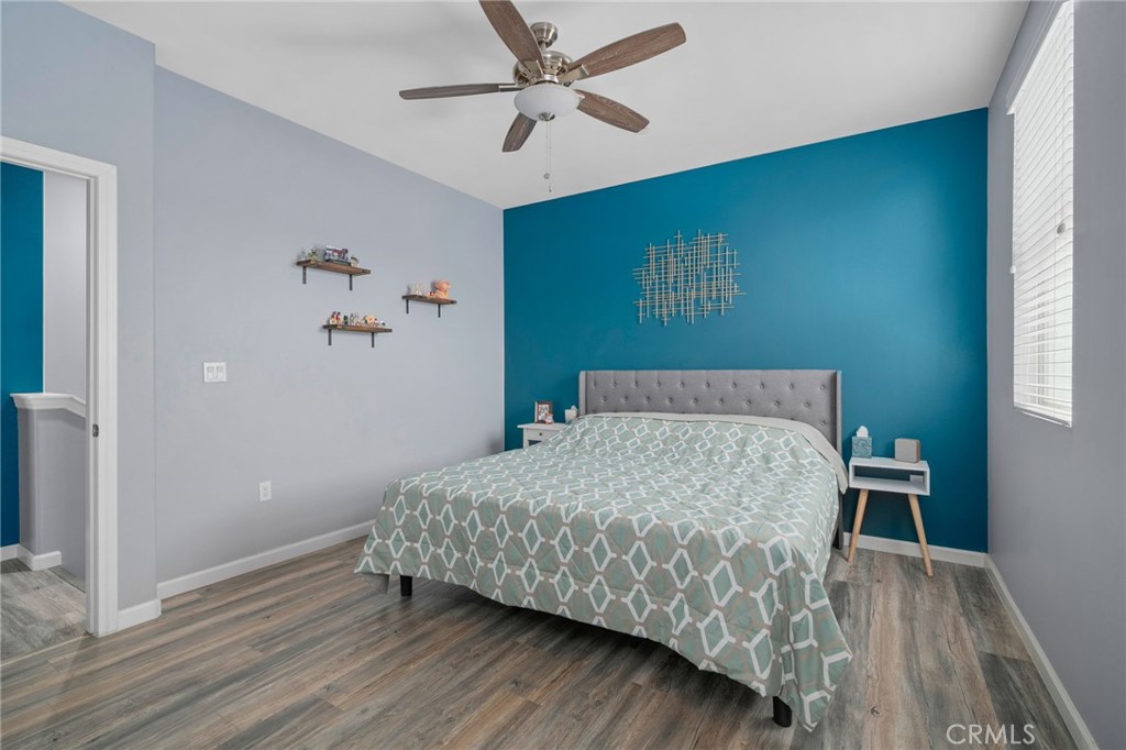 4171 South Cardinale Privado, Unit 2 Ontario, CA 91761 - Photo 15 of 30 a bedroom with a bed and wooden floor