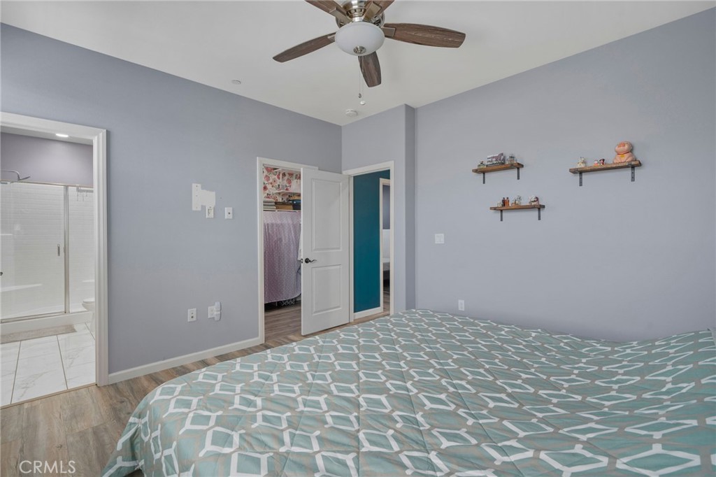 4171 South Cardinale Privado, Unit 2 Ontario, CA 91761 - Photo 17 of 30 a bedroom with a bed and a chandelier fan