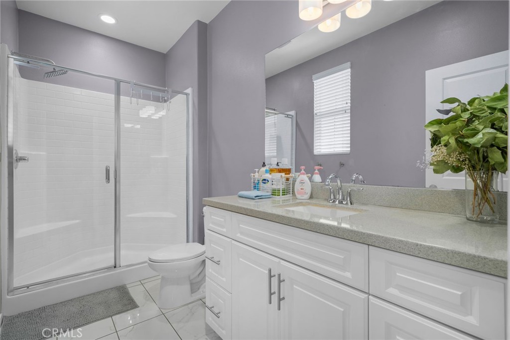 4171 South Cardinale Privado, Unit 2 Ontario, CA 91761 - Photo 18 of 30 a bathroom with a granite countertop sink a toilet and a shower