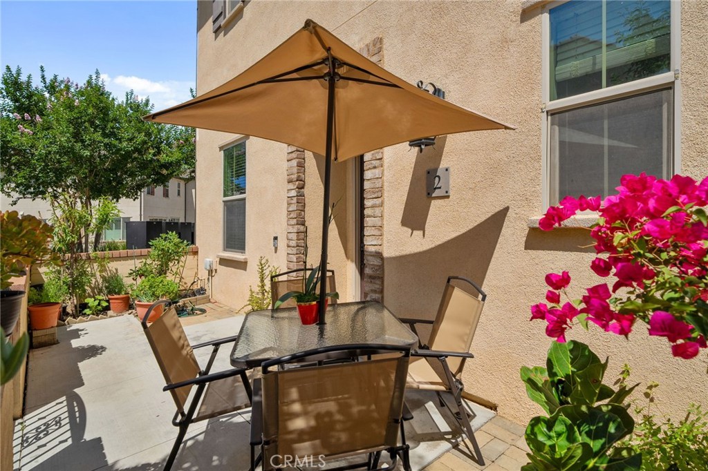 4171 South Cardinale Privado, Unit 2 Ontario, CA 91761 - Photo 22 of 30 a patio with table and chairs and potted plants