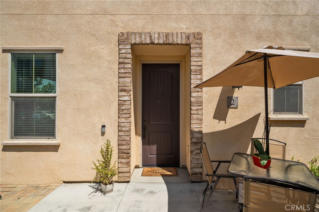 4171 South Cardinale Privado, Unit 2 Ontario, CA 91761 - Photo 23 of 30 a front view of a house with wooden floor and a table