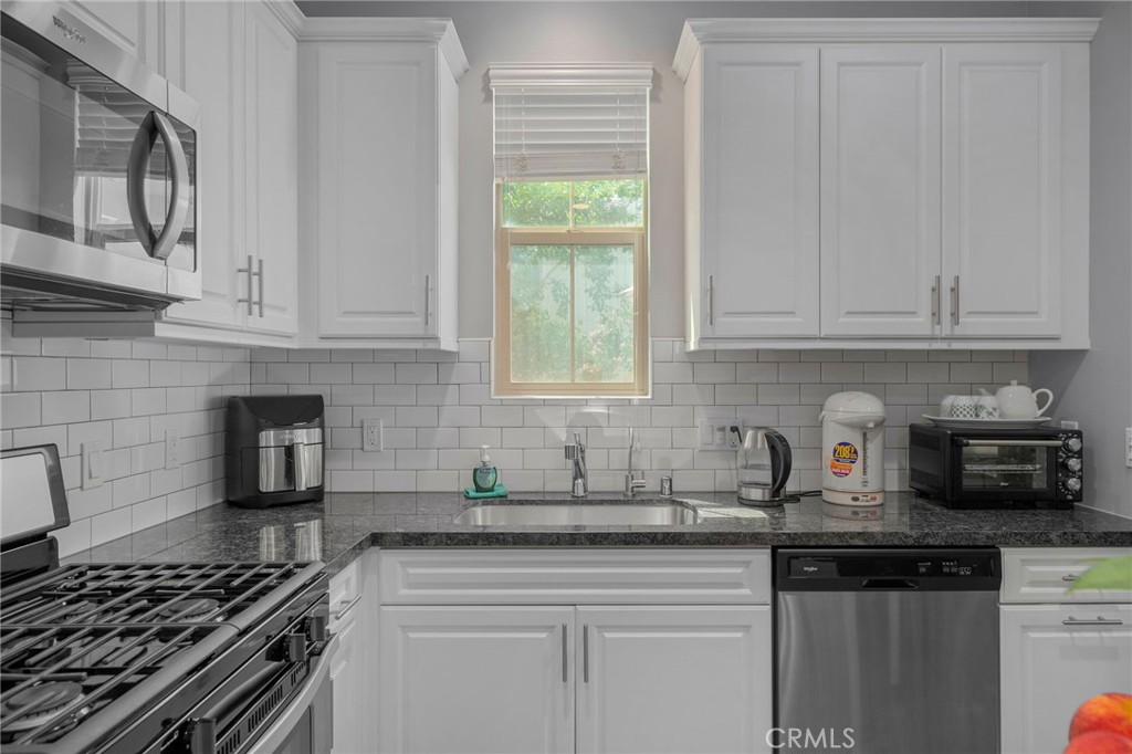 4171 South Cardinale Privado, Unit 2 Ontario, CA 91761 - Photo 8 of 30 a kitchen with stainless steel appliances granite countertop a sink stove and cabinets