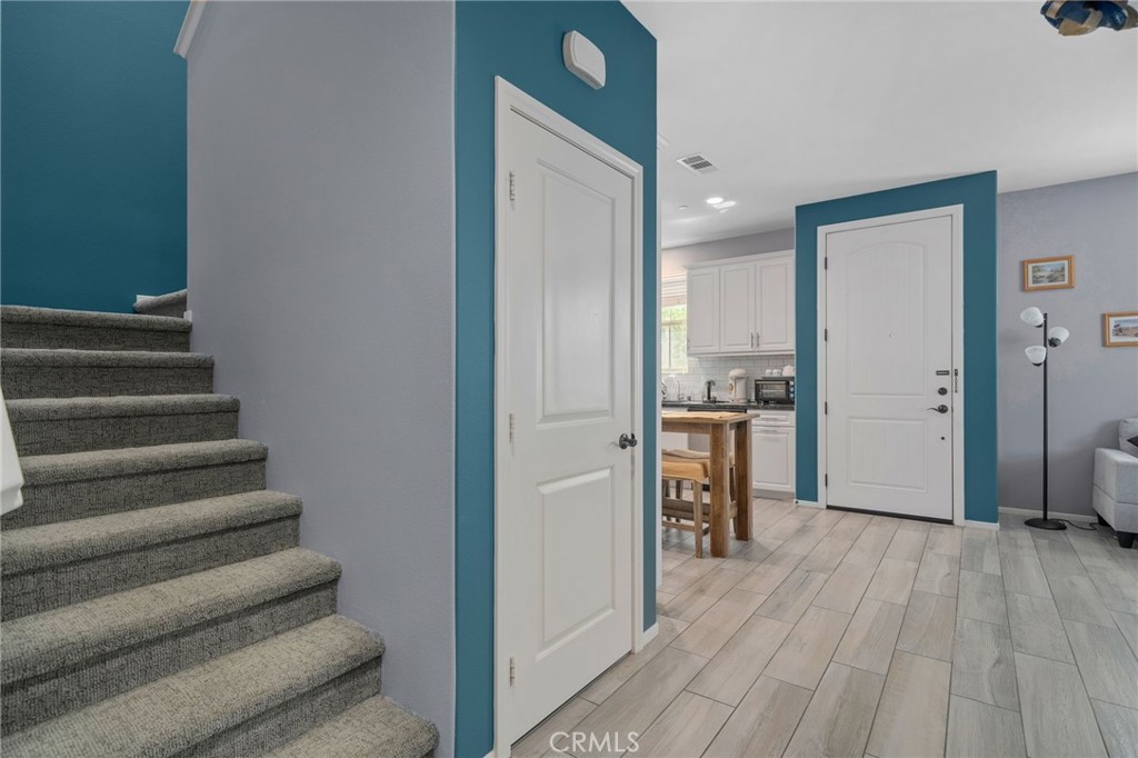 4171 South Cardinale Privado, Unit 2 Ontario, CA 91761 - Photo 10 of 30 a view of a hallway with wooden floor and dining room
