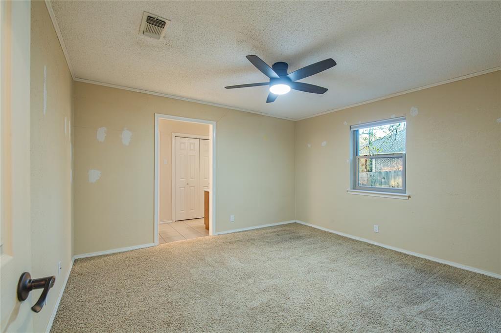 905 Martha Lane Azle, TX 76020 - Photo 18 of 18 Unfurnished room featuring ornamental molding, light carpet, a textured ceiling, and ceiling fan