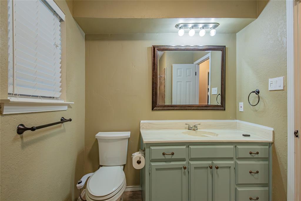 905 Martha Lane Azle, TX 76020 - Photo 10 of 18 Bathroom with a textured wall and vanity