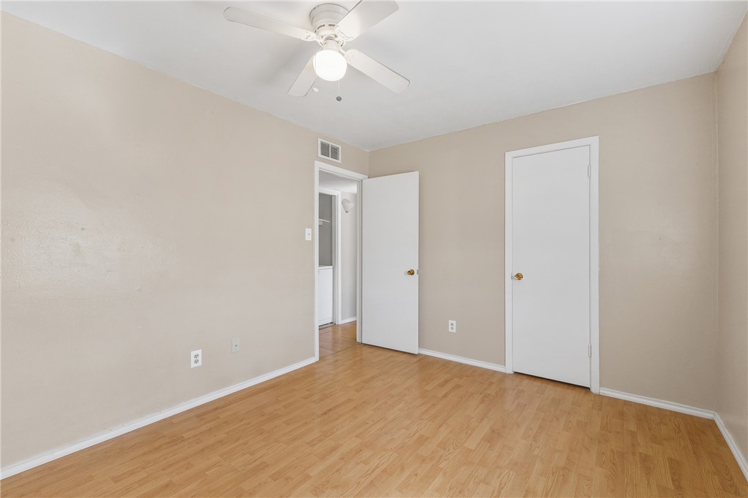 2802 Cypress Bend Circle Bryan, TX 77801 - Photo 11 of 15 an empty room with a ceiling fan and a window