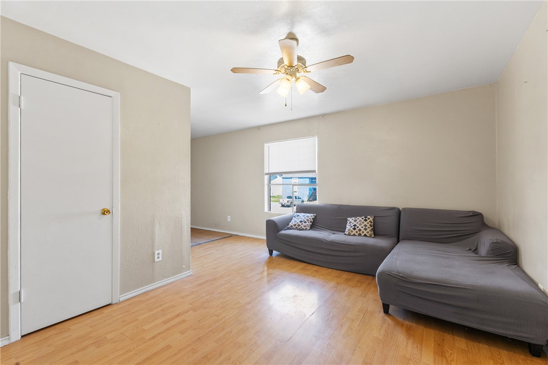 2802 Cypress Bend Circle Bryan, TX 77801 - Photo 2 of 15 a living room with couches and a ceiling fan with wooden floor