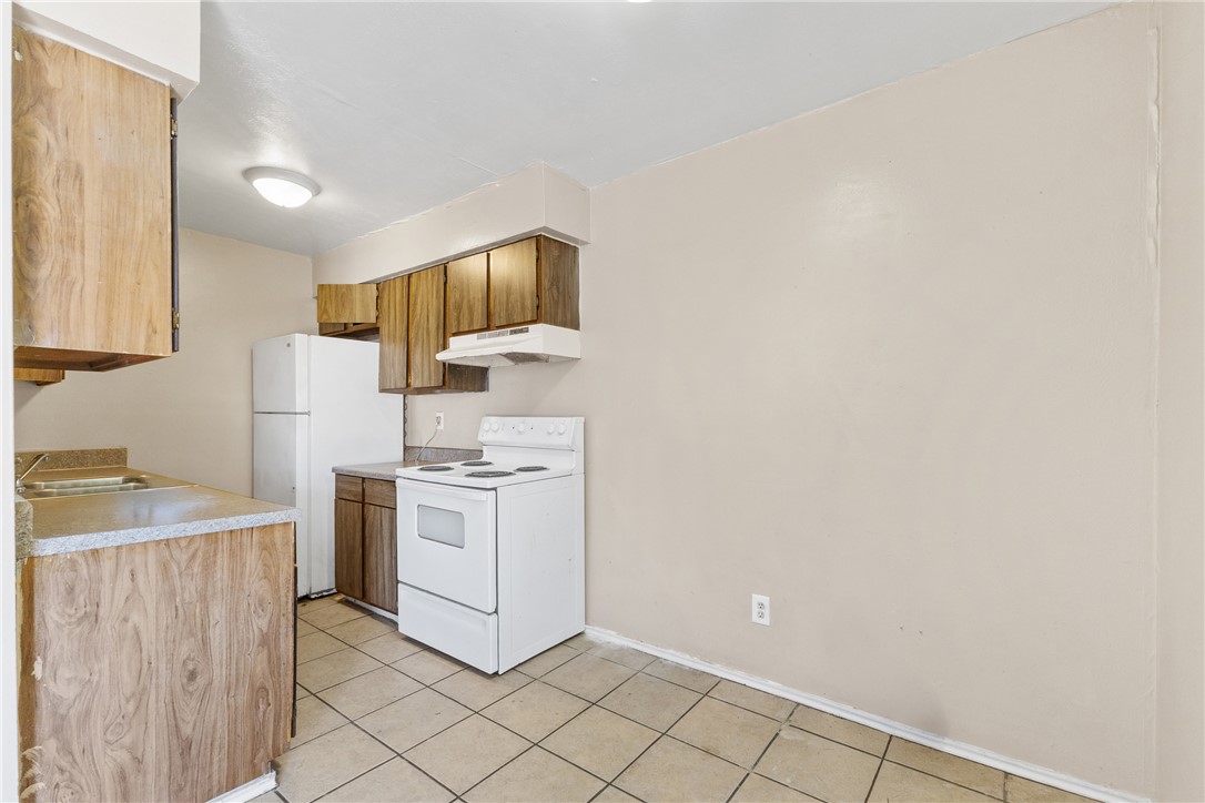2802 Cypress Bend Circle Bryan, TX 77801 - Photo 4 of 15 a kitchen with a stove and a refrigerator