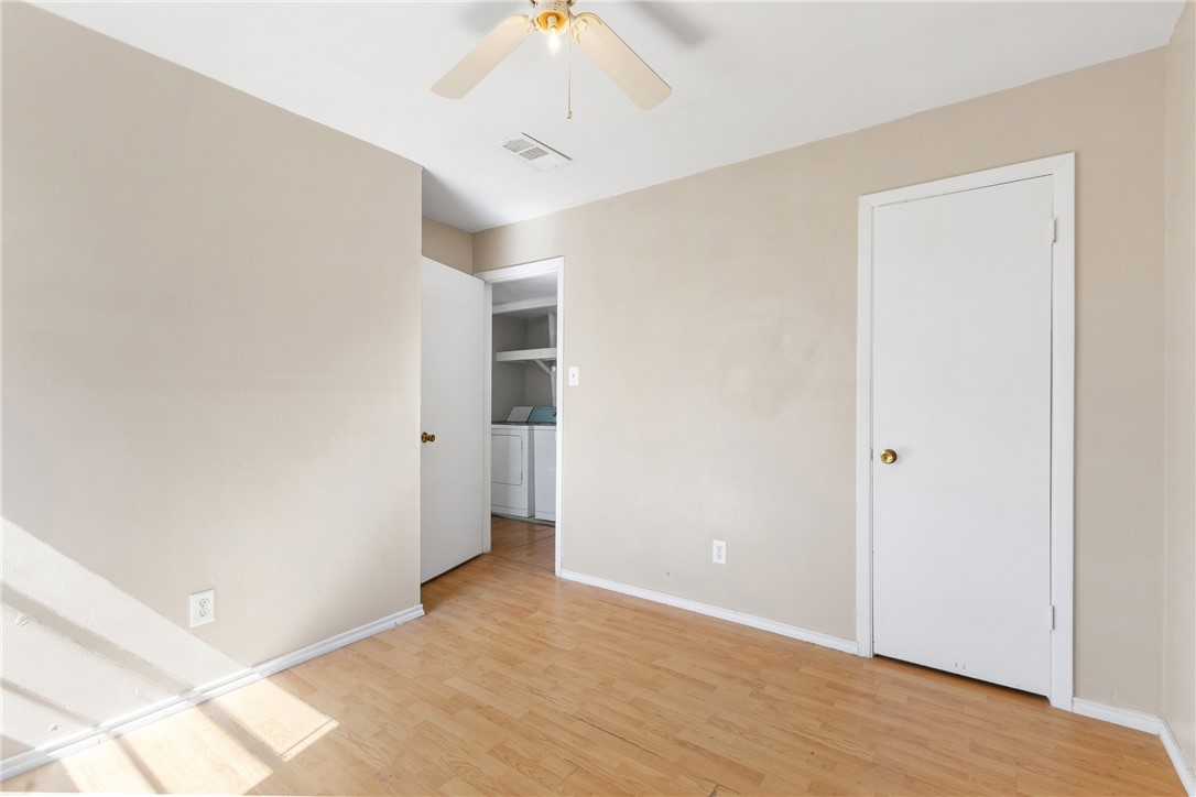 2802 Cypress Bend Circle Bryan, TX 77801 - Photo 7 of 15 a view of a hallway with wooden floor and closet area