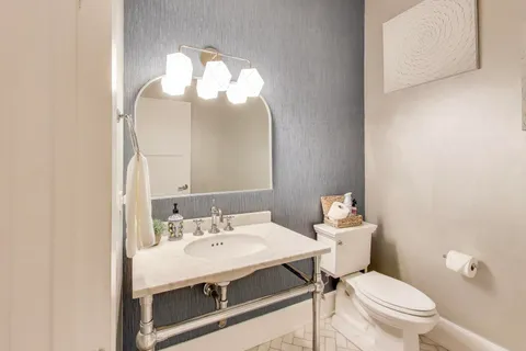 a bedroom with furniture and a wooden floor