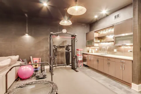 a view of a patio with couches chairs and wooden floor